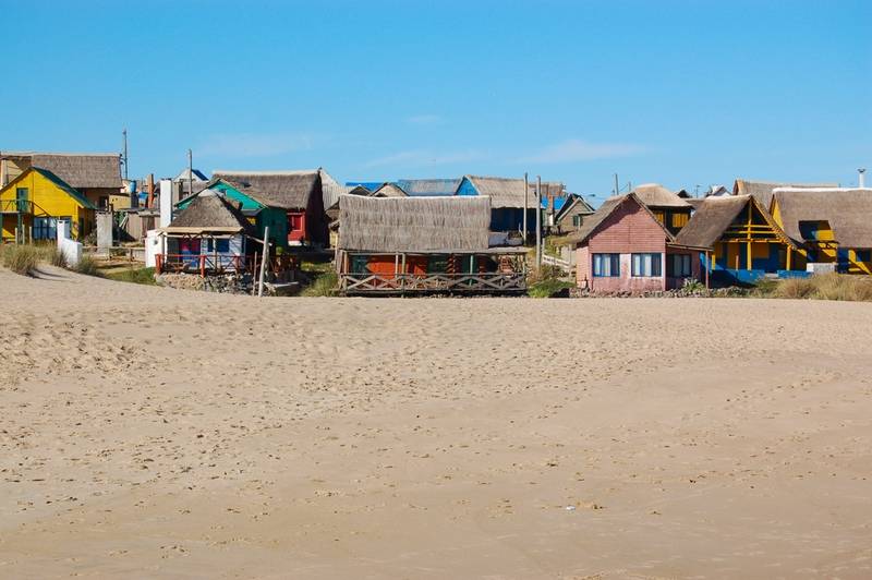 Colourful beach huts in Aguas Dulces
